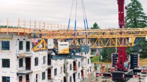 Bigfoot Crane Company Liebherr 81 K.1 Crane being lifted on a job site in Nanaimo